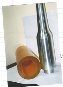 An isostatic press mold created bag and molding core pin shown.