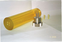 A bag and pressing mandrel created by a cold isostatic press mold are shown.